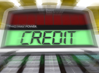 Close-up on calculator screen showing the word Credit