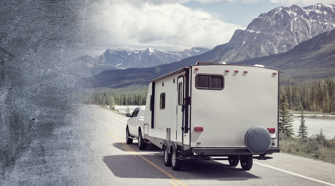 truck pulling r v camper down highway