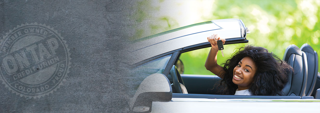 women in car holding up keys