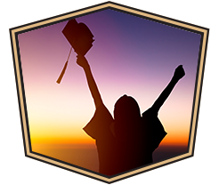 silhouette of graduate with hands in the air
