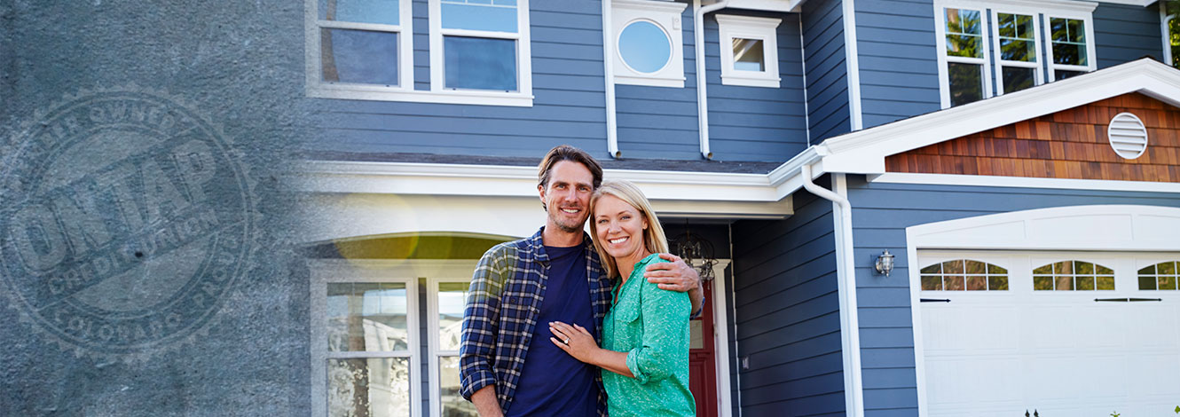 couple standing in front of home