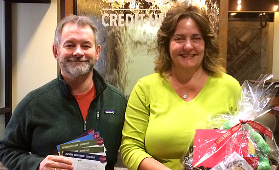 On Tap members with gift basket and tickets in a branch lobby