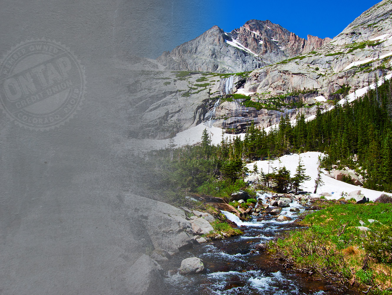 Mountain stream with snow topped peaks